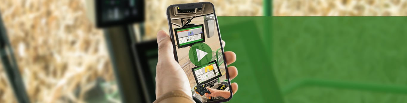 Image of someone taking a photo with a cell phone in a combine cab