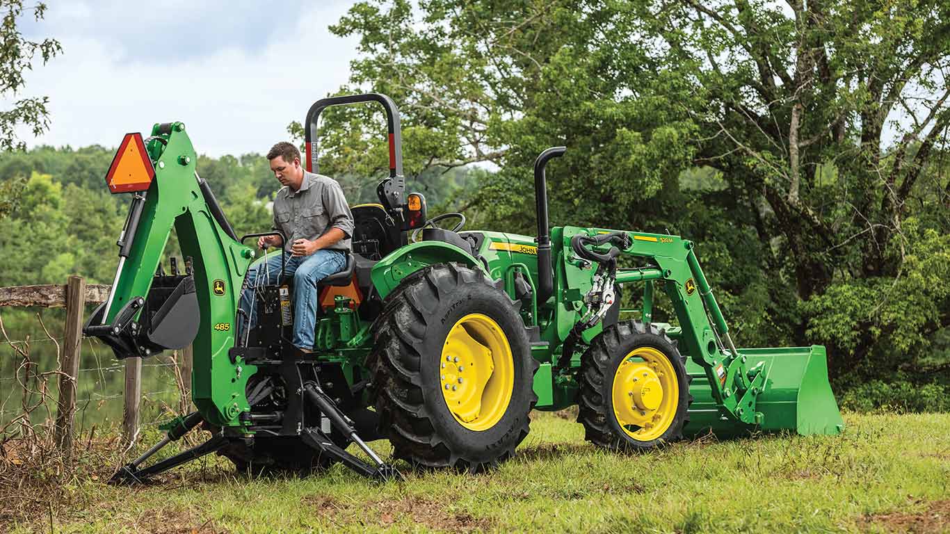 5e family tractor using backhoe digger in field