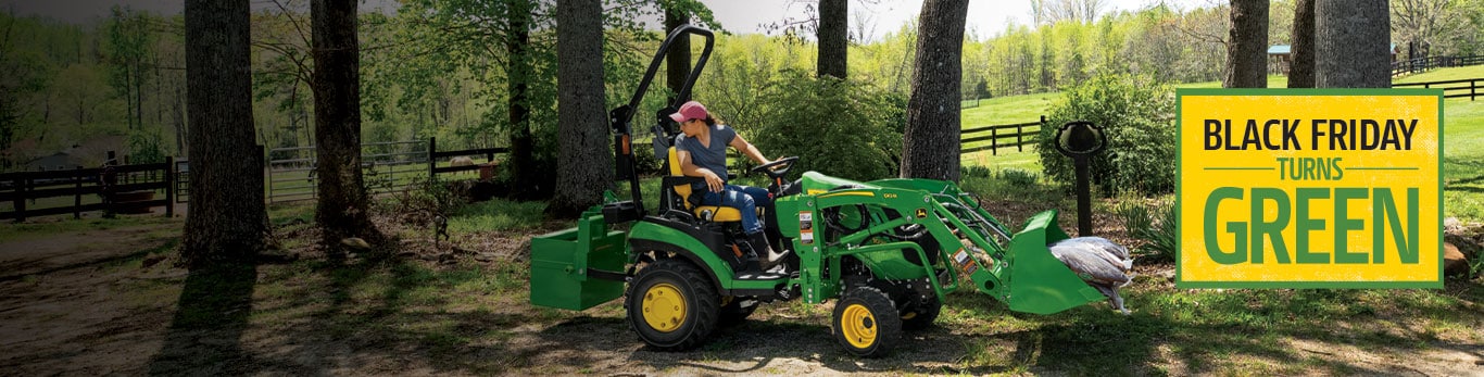 Person driving a compact utility tractor 