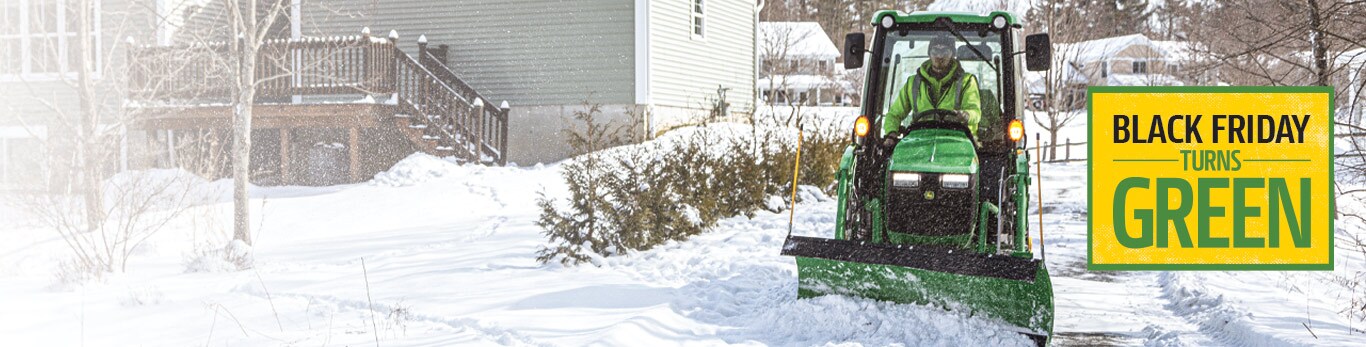 tractor plowing through snow
