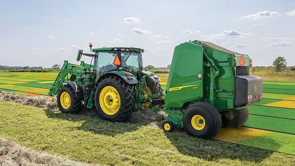 Tractor and baler baling a hay field with mapping on the field