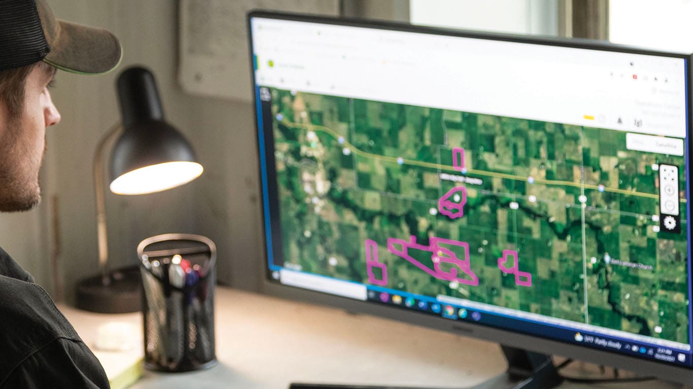 Person viewing John Deere Operation Center on a computer