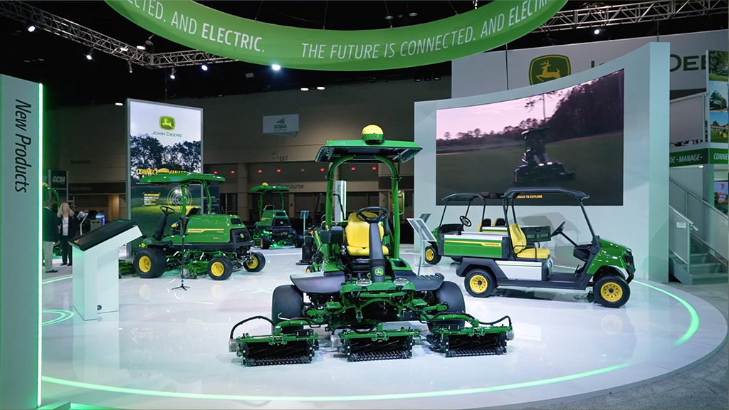 Image of fairway mowers and turf gator on a turn table at a show