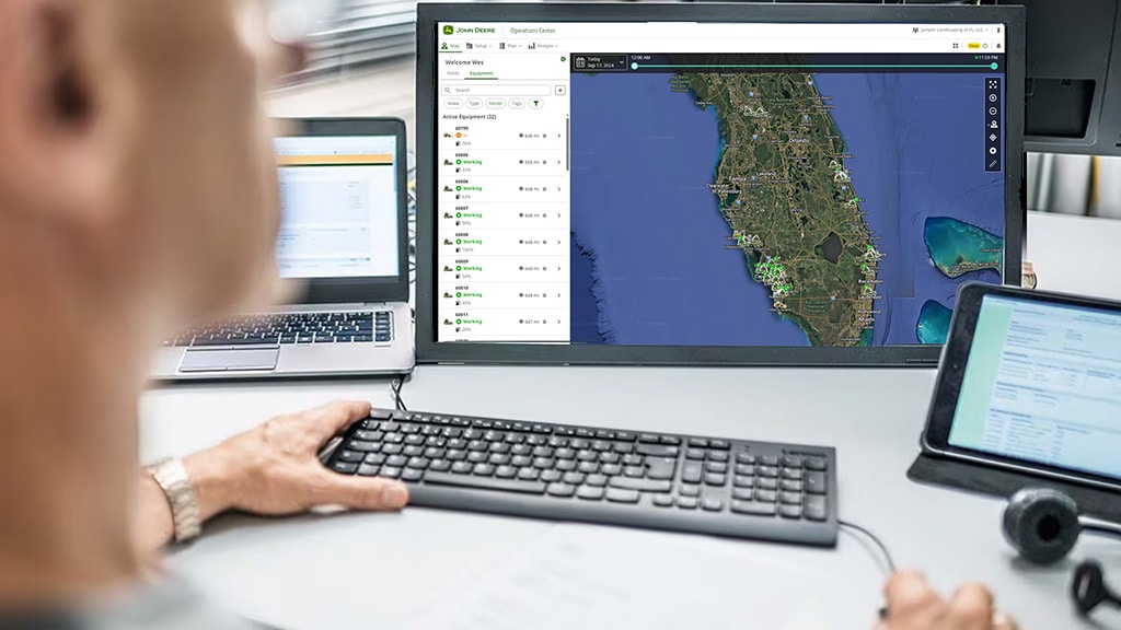A monitor displays an overview of Florida with a list of operating equipment off to the left of the screen.