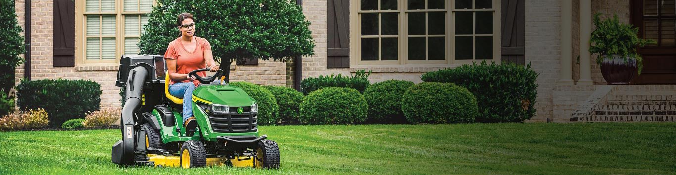 A woman mowing her lawn with an S100 mower