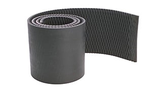 A roll of black rubber baler belt material.