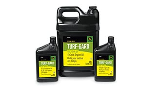 Containers of John Deere Turf-Gard oil.