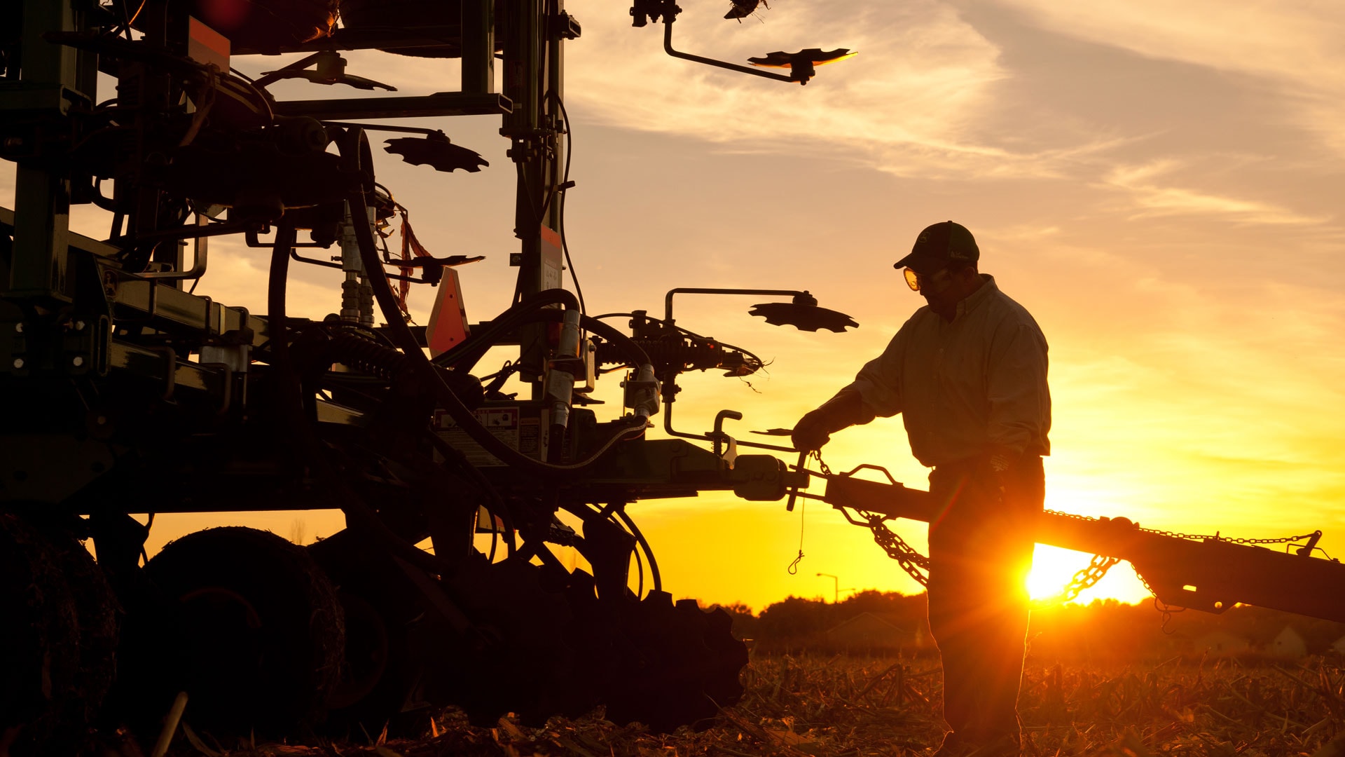 sunrise/sunset of sprayer equipment out in the field