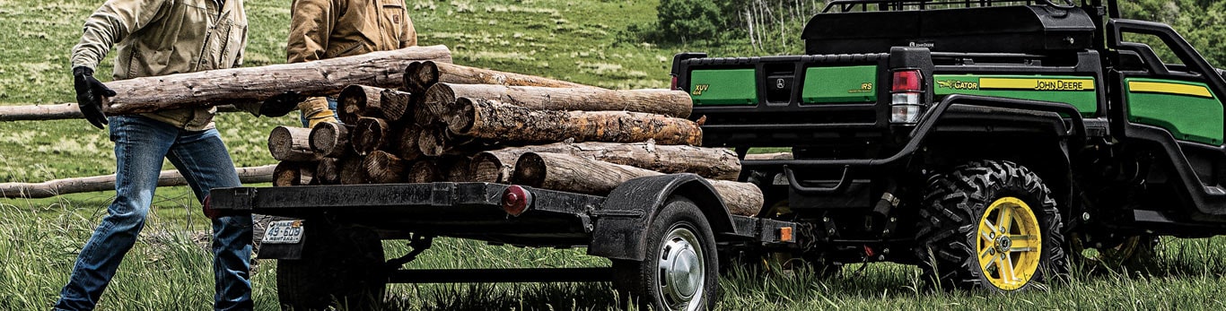 gator with winch attachment hauling logs