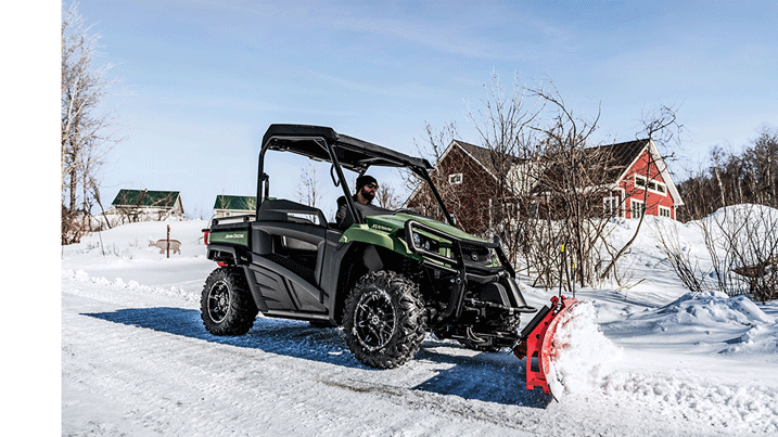  Person clearing snow with a Gator™ Utility Vehicle equipped with a blade