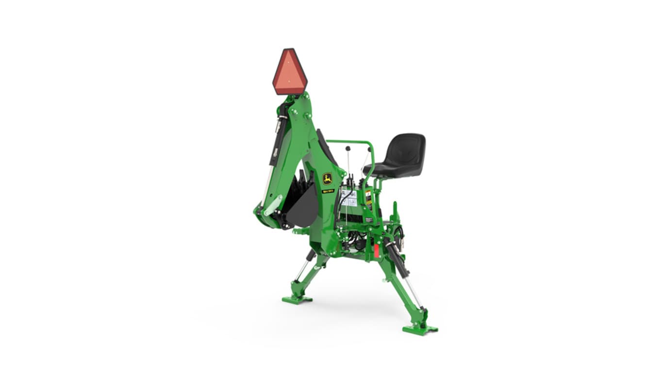 A front-left-facing studio shot of a green backhoe implement on a white background.