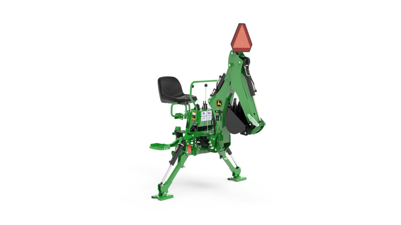 A front-right-facing studio shot of a green backhoe implement on a white background.