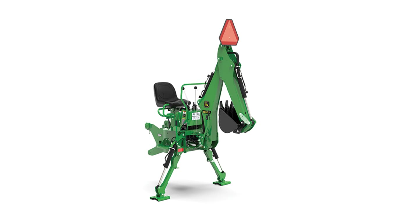 A front-right-facing studio shot of a green backhoe implement on a white background.
