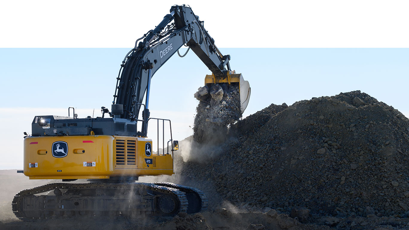 A 470P-Tier excavator scooping rocks off a stock pile.