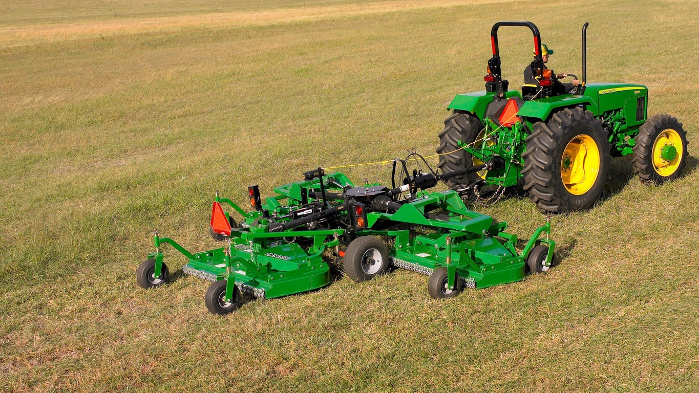 field image of Frontier™ FM10 flex-wing grooming mower attached to a tractor