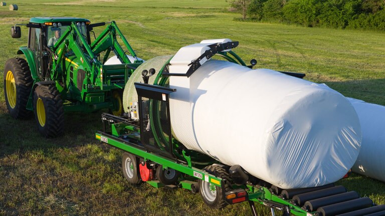 field image of Frontier™ LW12 inline bale wrapper attached to a tractor