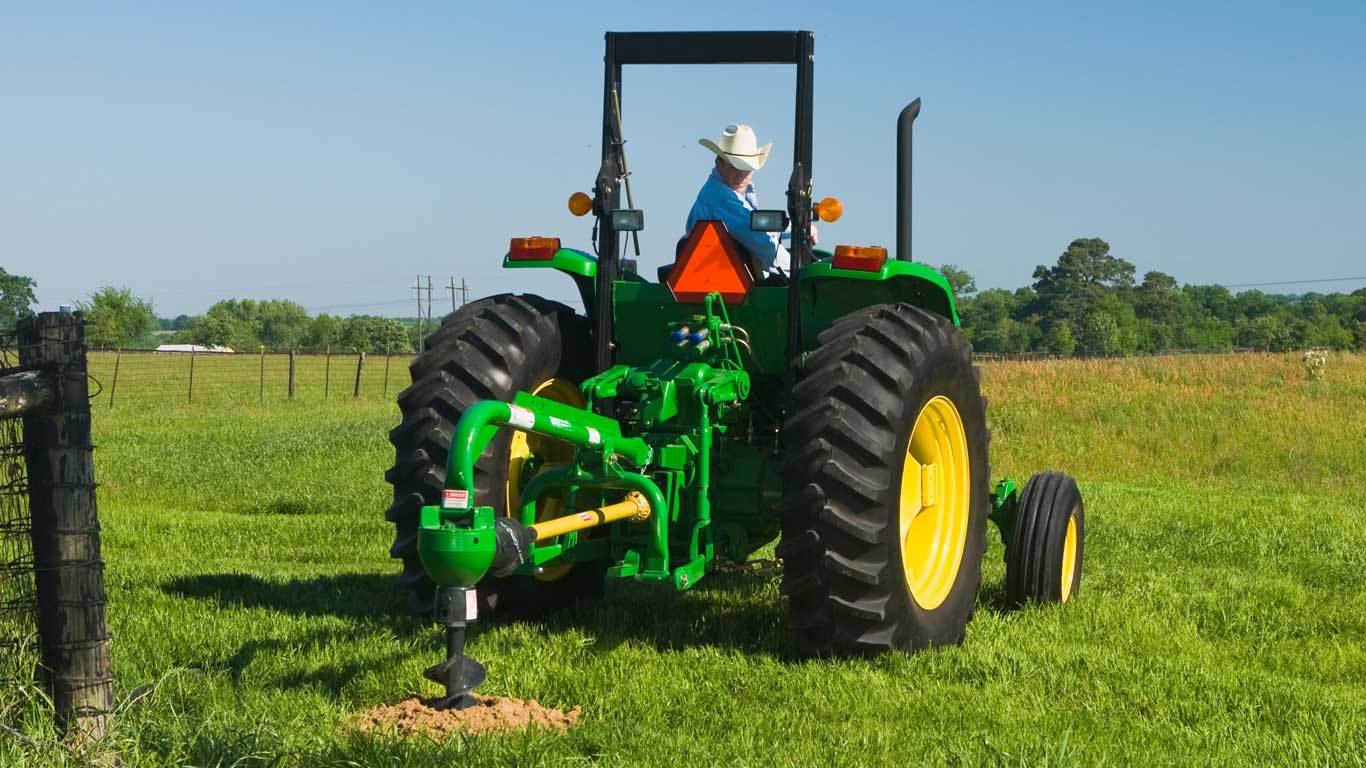 Front end loader top post hole digger