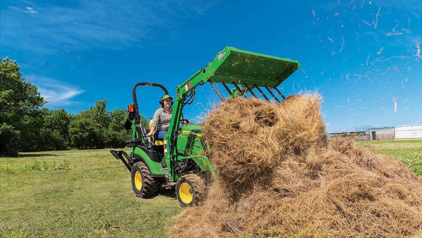 A woman on an am20 manure fork