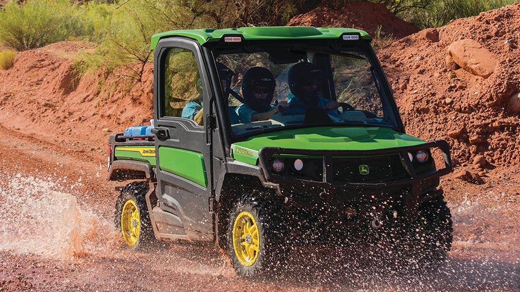 full-size gator™ driving through muddy/watery trail