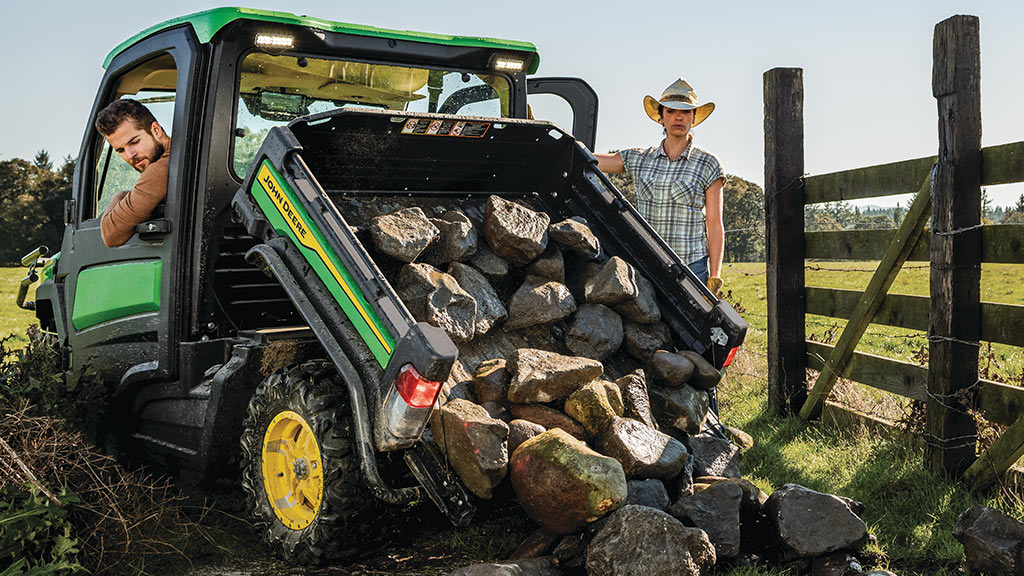 John Deere 2024 XUV835M towing 1,500lbs of rock and auto dumping it on the ground