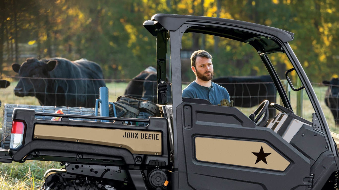Field shot of XUV835M Honor Edition with cattle worker