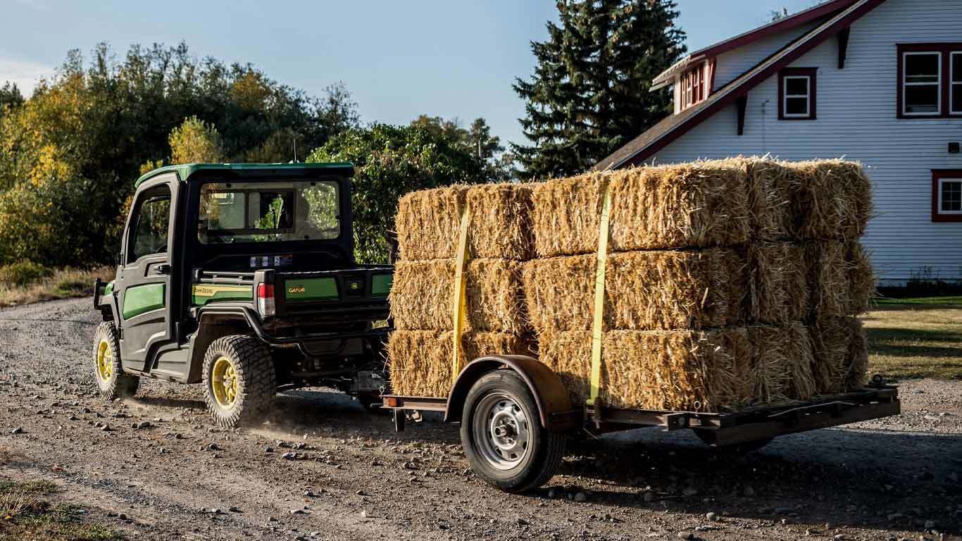 XUV865R Signature Edition pulling square hale bales.
