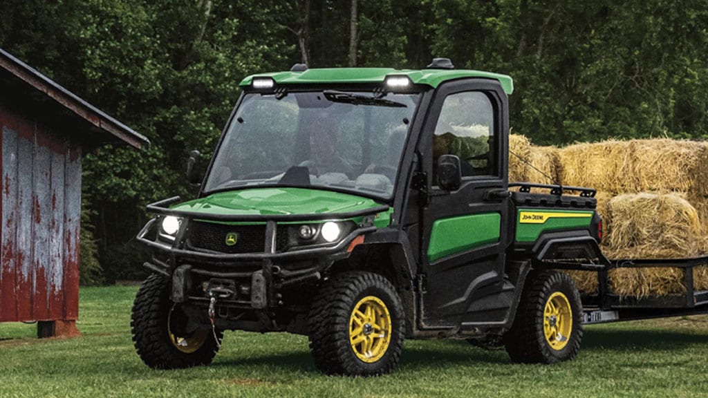 XUV 845R pulling bales of hay
