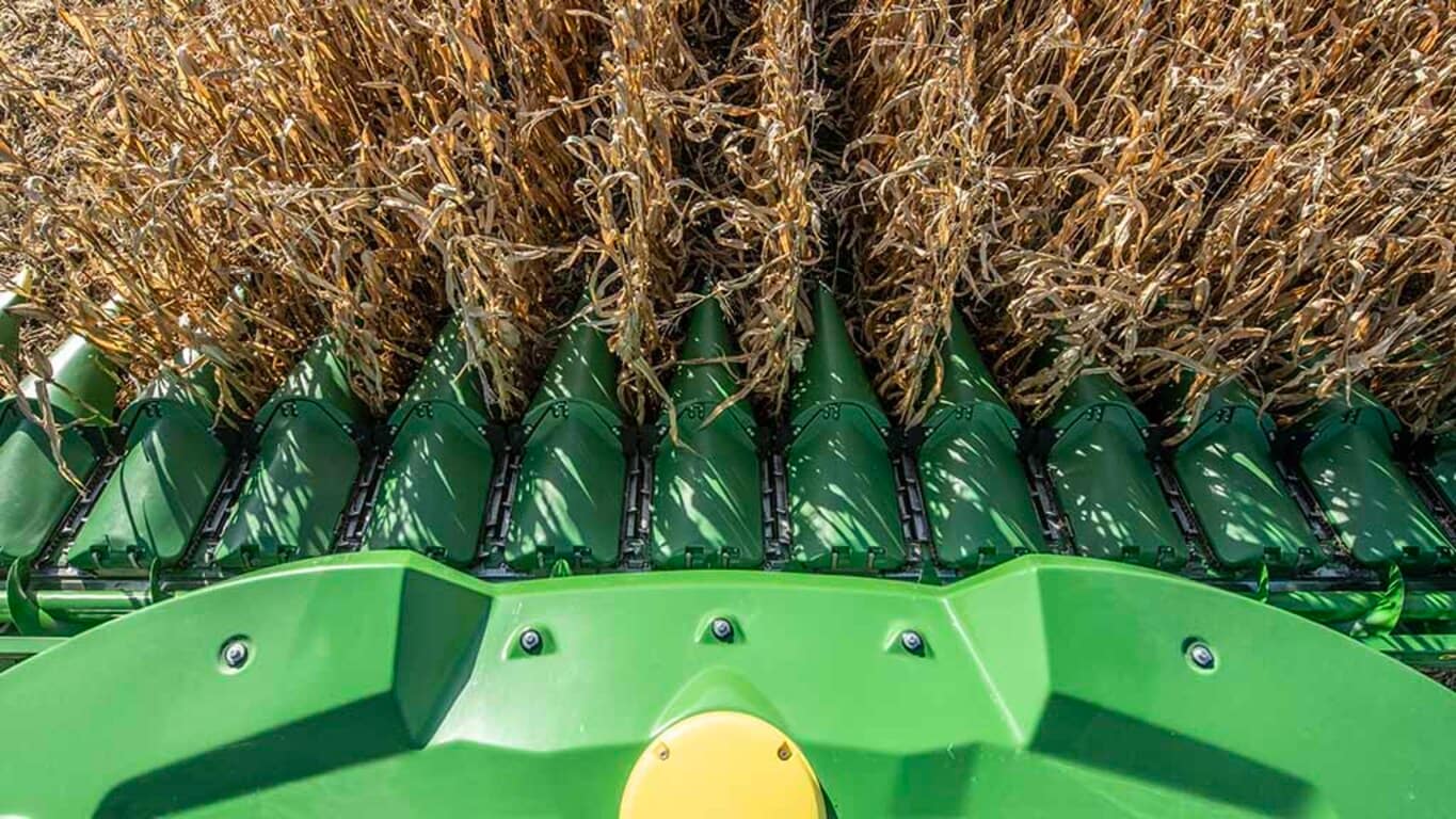 Overhead photo of a John Deere Combine harvesting corn with a CF12 Folding Corn Head