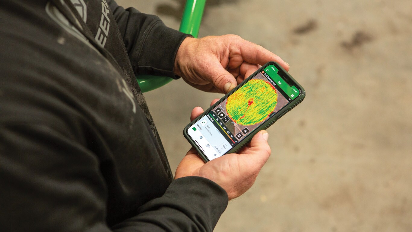 picture of a man holding a cell phone with the connect mobile app on screen