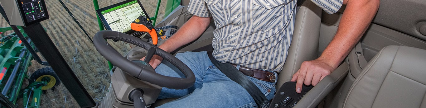 Photo of a farmer sitting in the cab of a S7 Combine