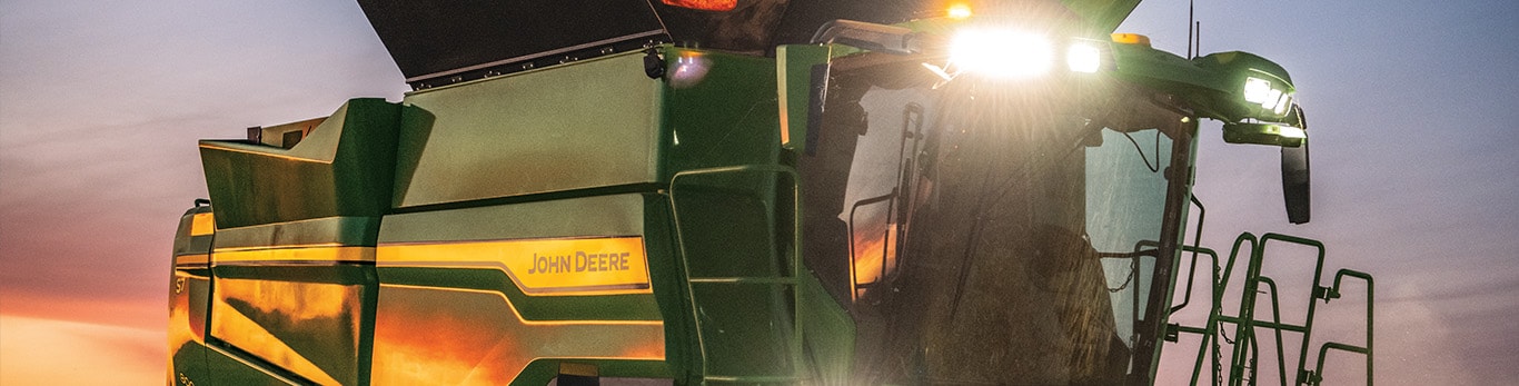 Photo of a S7 Combine at dusk as the combine's lights come on