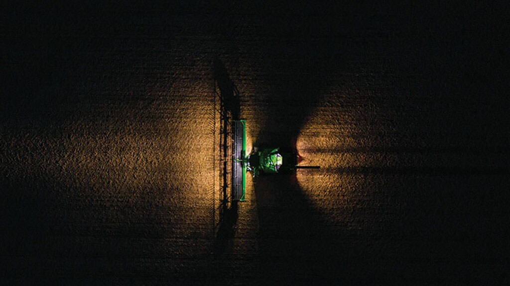 Combine in field at night with premium lighting package