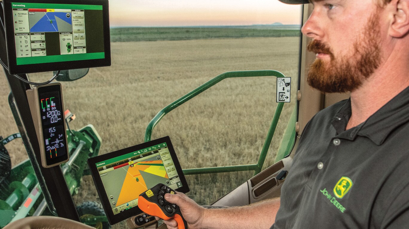 Person inside an S Series combine cab in field
