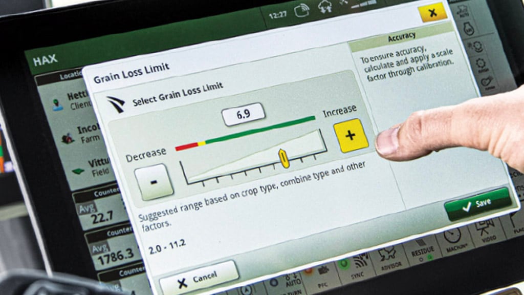 Close-up photo of a  farmer's hand adjusting the Grain Loss Limit run page on a G5Plus Display