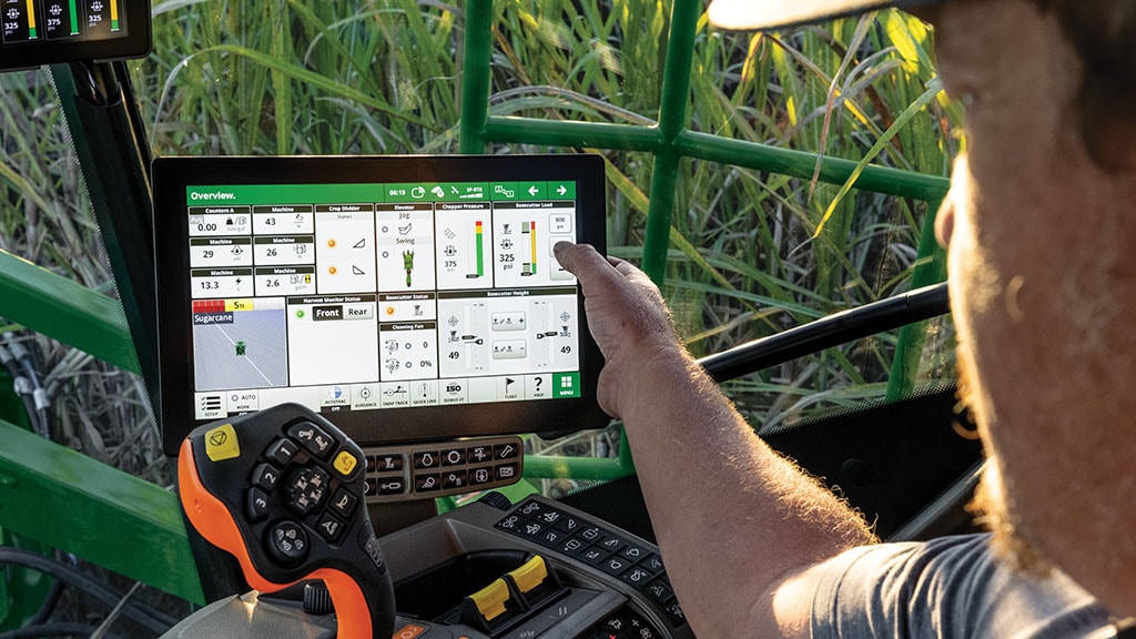 Close-up, in-cab photo showing a farmer interacting with his G5 Display in a CH Series Sugar Harvester.
