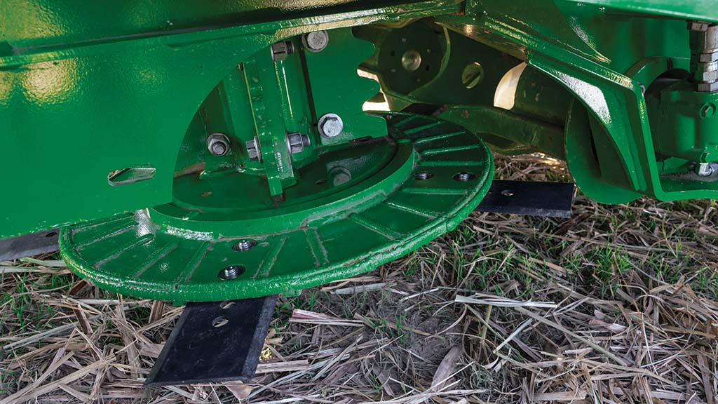 Close-up photo showing the center-driven basecutter on a CH Series Sugar Harvester.
