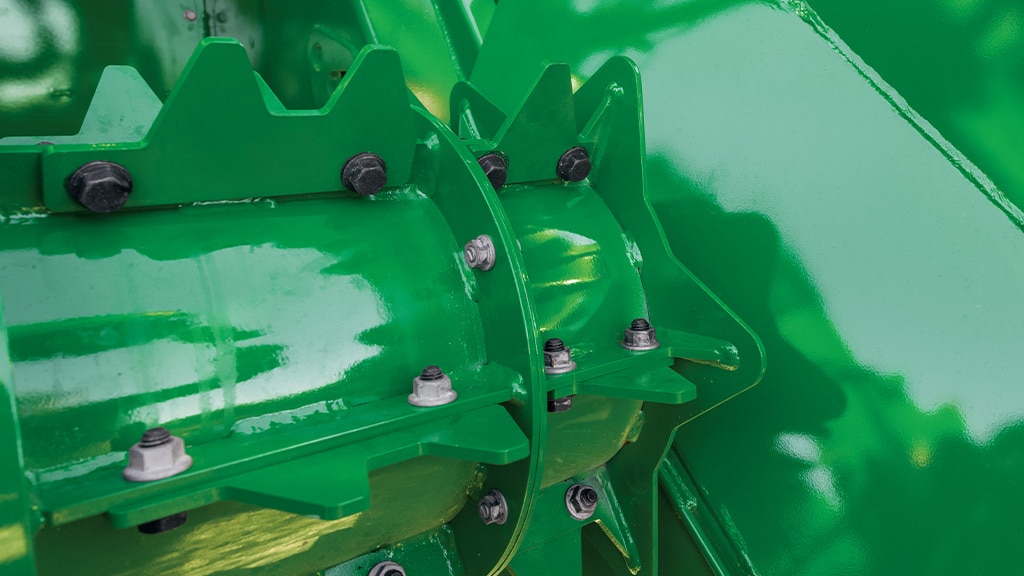 A close-up photo showing the scalloped knockdown roller end caps on a CH Series Sugar Harvester.