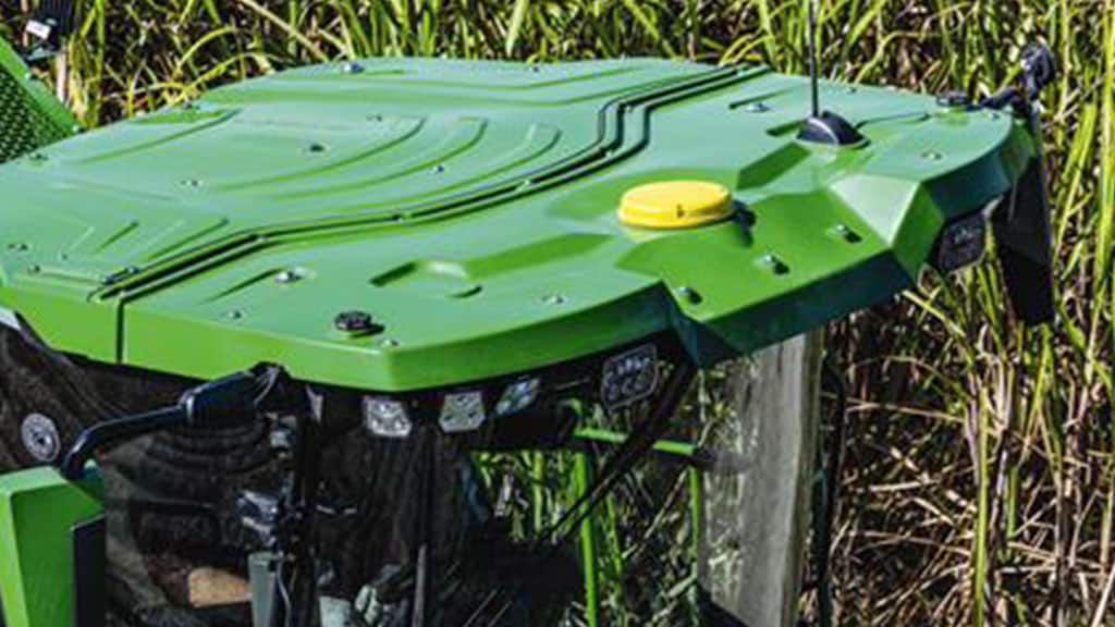 Overhead photo showing an integrated StarFire Receiver on the cab roof of a CH Series Sugar Cane Harvester working in standing crop.