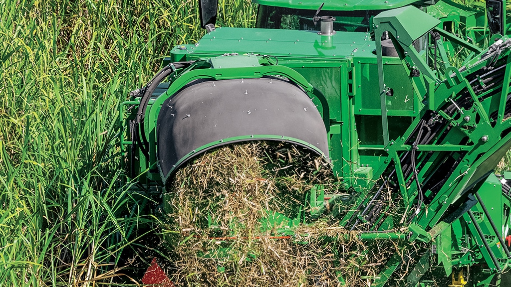 Close-up photo showing cane trash flowing from the optimized primary extractor on a CH Series Sugar Harvester.