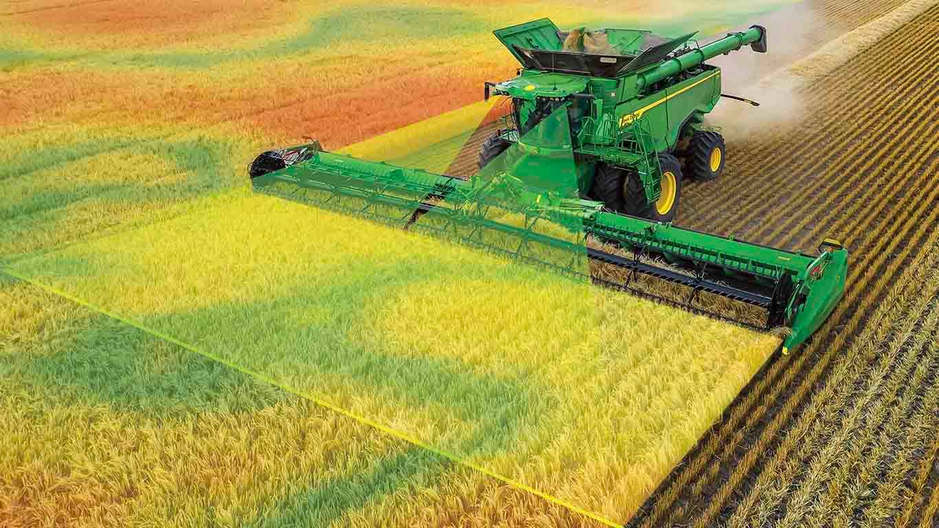 Photo of an X9 Combine harvesting wheat with a draper head. Graphics simulate front cameras scanning the crops, which comes with Predictive Ground Speed Automation