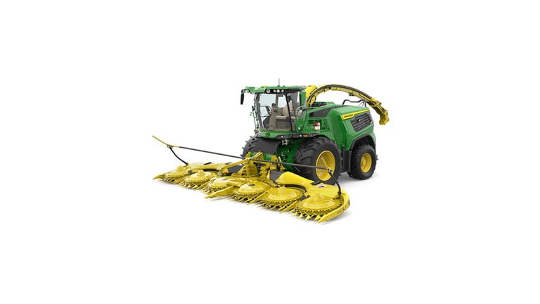 A front-left-facing green F9 700 self-propelled forage harvester with a yellow header on a white background.