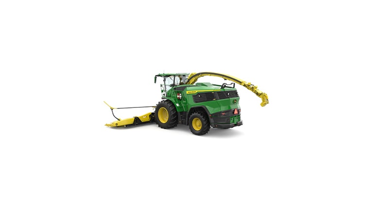 A rear-left-facing green F9 700 self-propelled forage harvester with a yellow header on a white background.