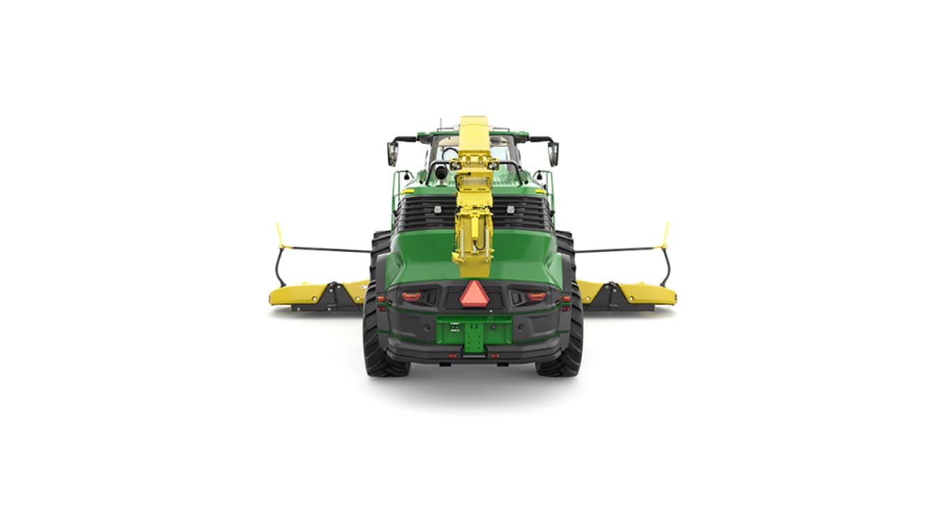 A rear-facing green F9 700 self-propelled forage harvester with a yellow header on a white background.