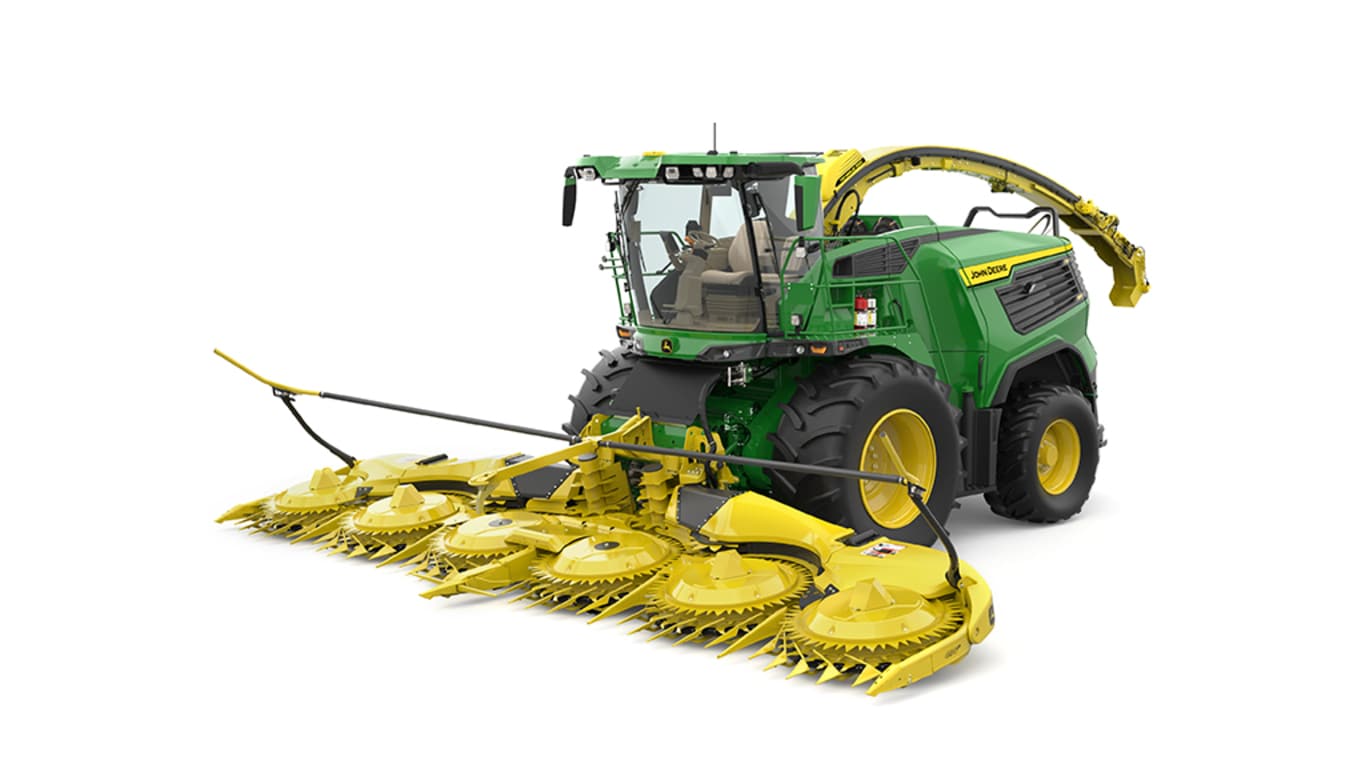A front-left-facing green F9 1000 self-propelled forage harvester with a yellow header on a white background.