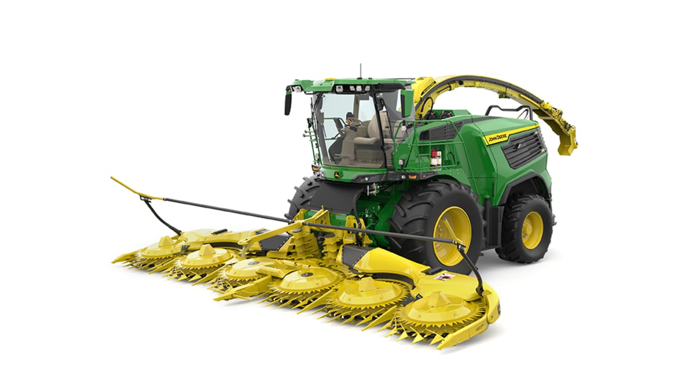 A front-left-facing green F9 900 self-propelled forage harvester with a yellow header on a white background.