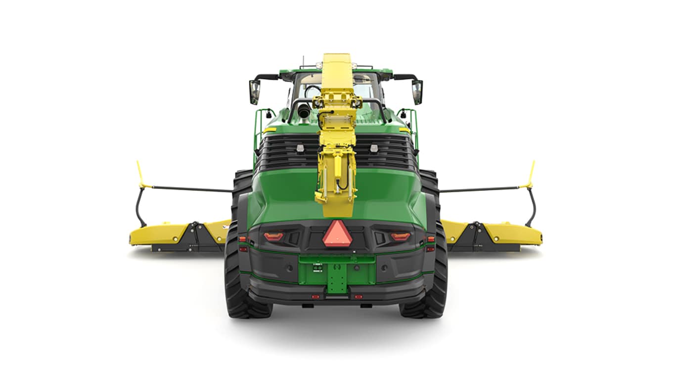 A rear-facing green F9 900 self-propelled forage harvester with a yellow header on a white background.
