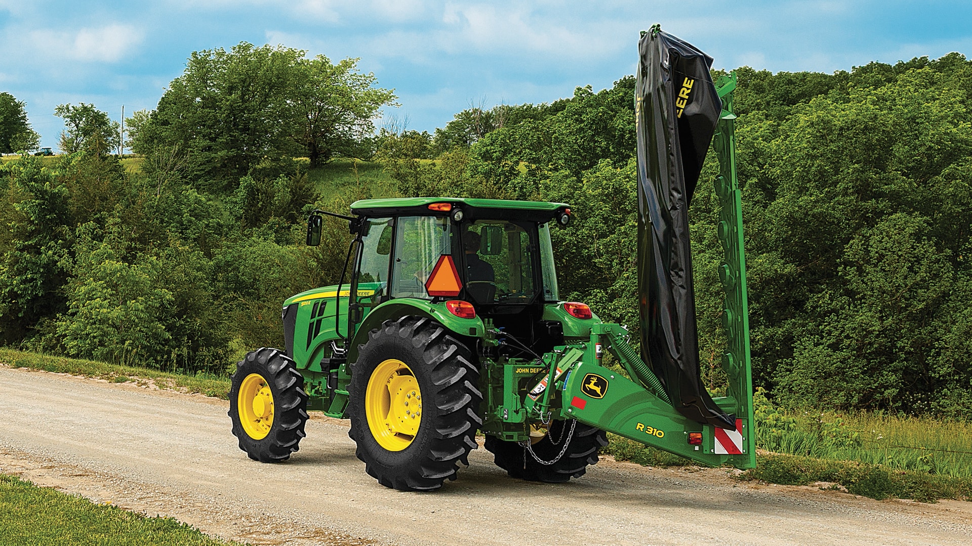 fold and go tractor moving down road photo