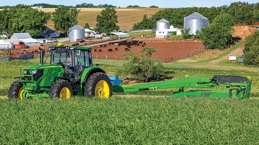 tractor and mower conditioner in a field