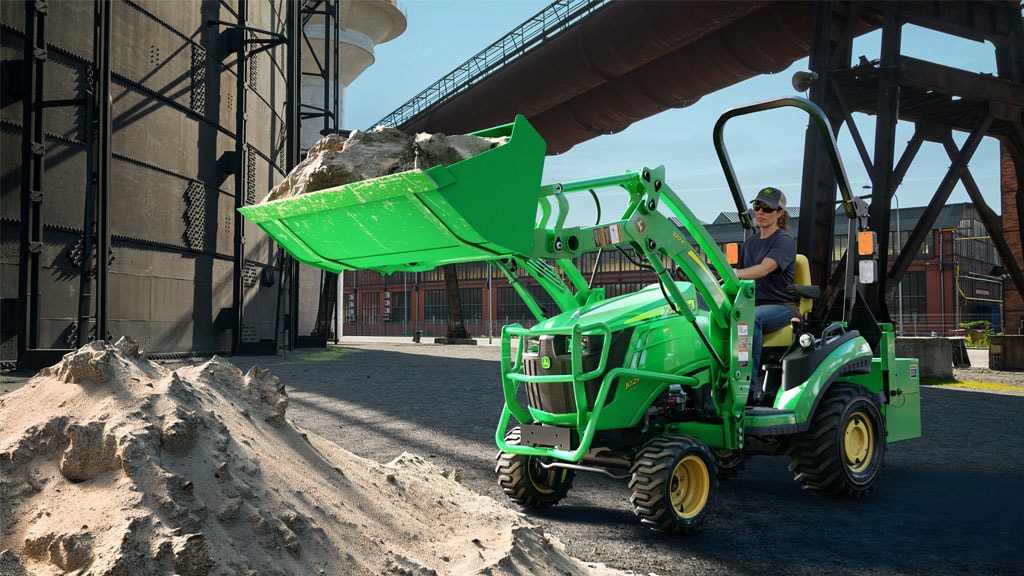 tractor with front end loader lifting gravel