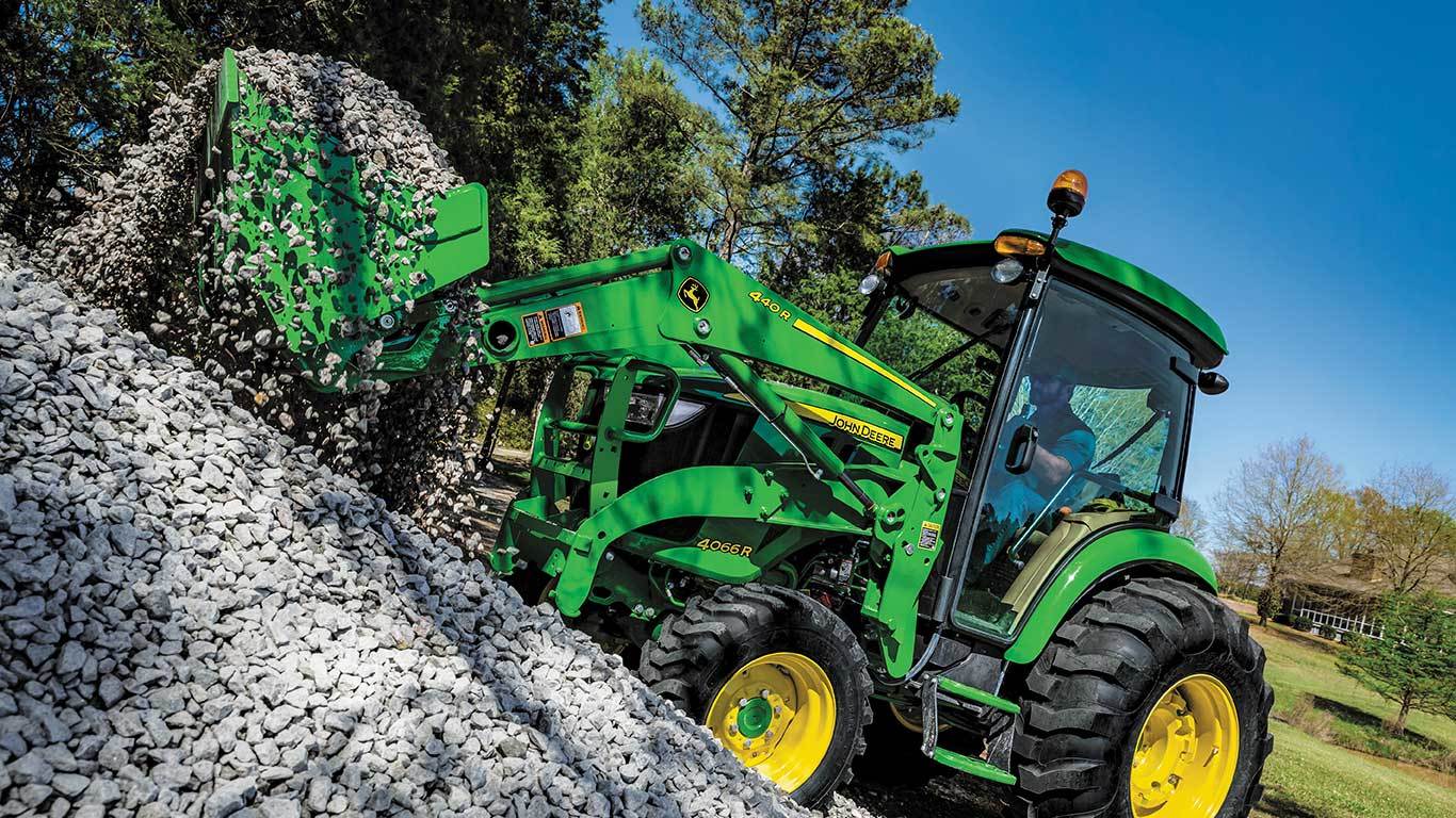 4 series tractor with a 440R loader lifting gravel